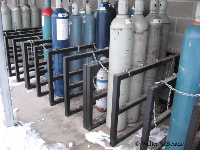 How should oxygen cylinders be stored?